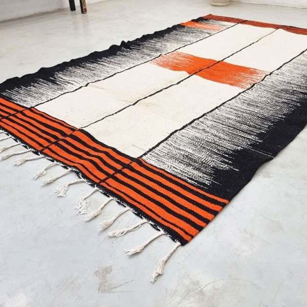 Alfombra Kilim naranja y negra de tejido plano