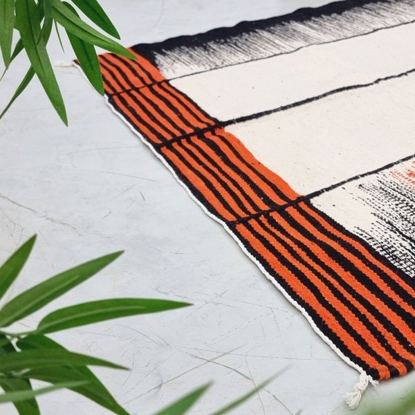 Alfombra Kilim naranja y negra de tejido plano